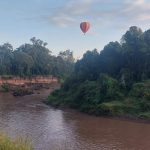 hot air balloon over hills 1